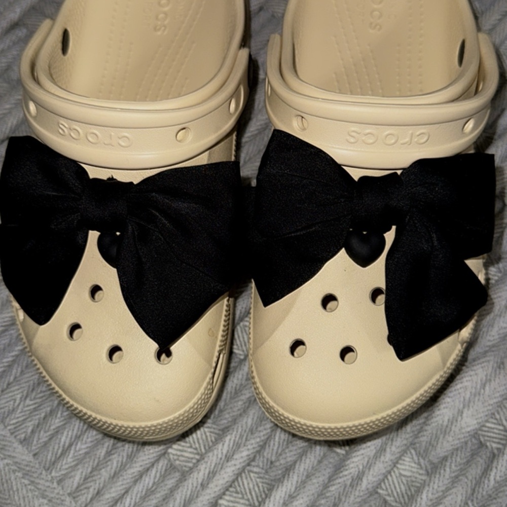 CROCS women’s Cream Sandals with Black Bow
